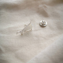Load image into Gallery viewer, Cornish map silver  pin which brooch back on plain fabric
