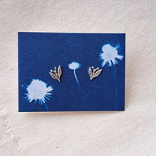 Load image into Gallery viewer, Silver nature stud earrings - leaves with berries, on indigo blue backing card with cyanotype image of dandelions