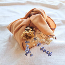 Load image into Gallery viewer, Reusable orange fabric gift wrap tied in know with dried flower posy, white gyspohila, blue lavendar and yellow flowers
