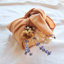Load image into Gallery viewer, Reusable orange fabric gift wrap tied in know with dried flower posy, white gyspohila, blue lavendar and yellow flowers