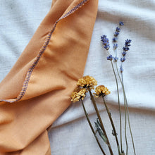 Load image into Gallery viewer, Orange fabric gift wrap with dried yellow flowers and blue lavendar
