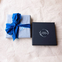 Load image into Gallery viewer, Black branded jewellery box, next to wrapped box in blue silk ribbon