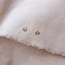Load image into Gallery viewer, Silver leaf stud earrings with tiny berries, on plan natural fabric background