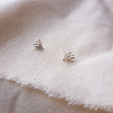 Load image into Gallery viewer, Silver leaf and berry stud earrings on plain natural calico fabric