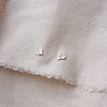 Load image into Gallery viewer, Silver leaf stud earrings on natural undyed cotton calico fabric