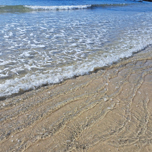 Small waves breaking on sand at Towan beach, Roseland Peninsula, Cornwall 