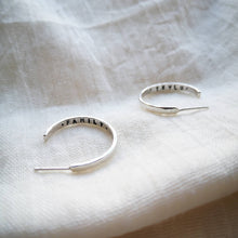 Load image into Gallery viewer, Silver medium sized hoop earrings with family and Teylu message inside (Teylu = cornish word for family)