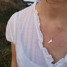 Load image into Gallery viewer, Mini Cornwall silver necklace worn with white shirt on Cornish cliffs