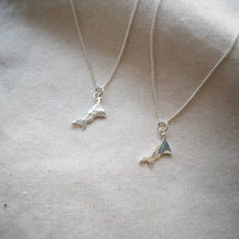 Load image into Gallery viewer, Two Lowen Cornwall map necklaces hanging from recycled silver chains on plain calico fabric