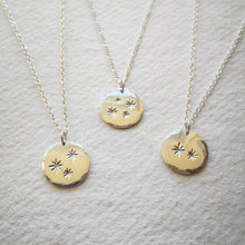 Load image into Gallery viewer, Three family star eco-silver disc necklaces with chains on natural cream paper background
