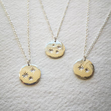 Load image into Gallery viewer, Three family star eco-silver disc necklaces with chains on natural cream paper background