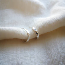Load image into Gallery viewer, Handmade silver hoop earrings front profile hammered textured finish on white muslin fabric