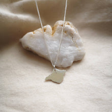 Load image into Gallery viewer, Recycled silver sustainable Isle of Wight necklace draped over white quartz stone on calico fabric