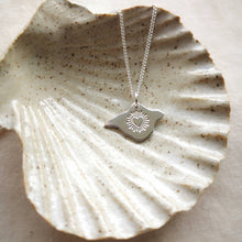 Load image into Gallery viewer, Isle of Wight shaped silver necklace with radiant heart engraving in ceramic shell dish