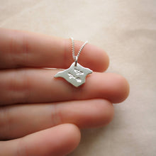 Load image into Gallery viewer, Hand holding silver Isle of Wight shaped necklace with three birds engraved on front