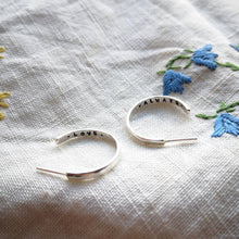 Load image into Gallery viewer, Silver hoop earrings with love always message stamped inside, on embroidered flower fabric blue flowers