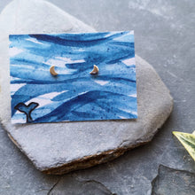 Load image into Gallery viewer, Half moon tiny eco silver studs on watercolour backing card of waves and a whale tail