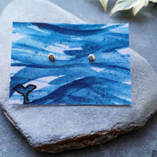 Load image into Gallery viewer, Tiny circle eco silver studs on watercolour backing card of waves and a whale tail
