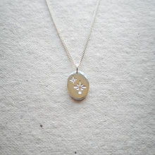 Load image into Gallery viewer, Engraved star necklace, oval shaped double-sided eco-friendly recycled silver pendant on natural paper