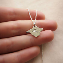 Load image into Gallery viewer, Recycled silver Isle of Wight shaped necklace with wave design, draped over fingers
