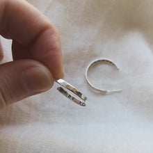 Load and play video in Gallery viewer, Fingers holding eco silver hoops showing messages inside hoops of be bold in one and be brave in the other