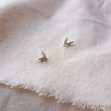 Load image into Gallery viewer, Silver leaf stud earrings on natural calico fabric background

