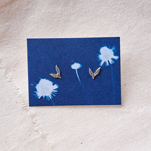 Silver leaf studs on backing card made from indigo blue dandelion cyanotype print