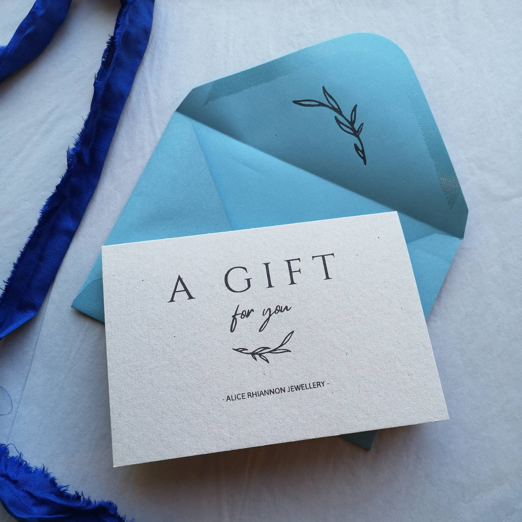 Alice Rhiannon Jewellery gift voucher natural card with light blue envelope and blue silk ribbon