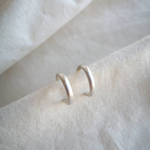 Silver hoops with brushed satin matte finish on calico fabric