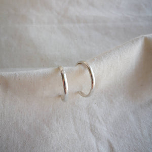Front view of simple classic silver hoops with high shine