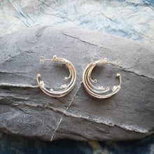 Load image into Gallery viewer, Recycled silver wild wave hoop earrings on grey stone
