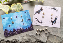 Load image into Gallery viewer, Tiny silver moon stud earrings set, on night sky forest and leaping foxes illustrated backing cards
