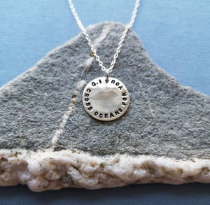 Silver coin necklace engraved with whale and ‘I’d cross oceans for you’ on back 