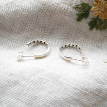 Load image into Gallery viewer, Mini silver hoop earrings with hope message inside, on fabric with embroidered yellow flower
