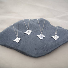 Load image into Gallery viewer, Isle of Wight necklace range, four necklaces with different finishes - wave engraving, birds engraving, heart engraving and textured finish 
