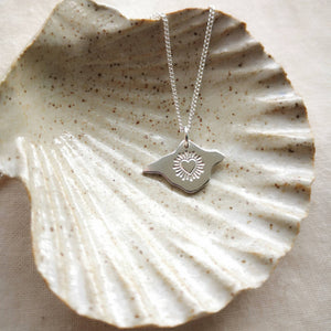 Isle of Wight shaped silver necklace with radiant heart engraving in ceramic shell dish