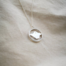 Load image into Gallery viewer, Isle of Wight recycled silver necklace, island map inside silver hoop on calico fabric
