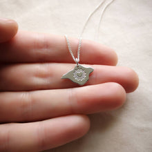 Load image into Gallery viewer, Recycled silver necklace with bursting heart design held on hand

