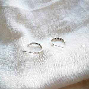 Recycled silver mini hoop earrings with love text inside hoop