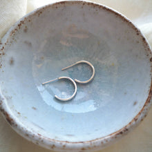 Load image into Gallery viewer, Mini silver hoop earrings side profile in light blue ceramic bowl, handmade in Cornwall
