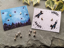 Load image into Gallery viewer, Tiny silver moon stud earrings on night sky forest and leaping foxes illustrated backing cards
