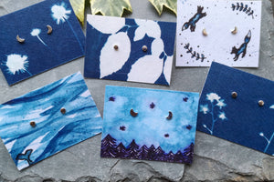 Tiny recycled silver moon studs on a selection of eco friendly illustrated backing cards