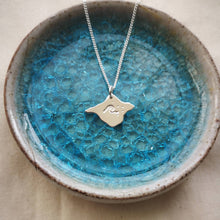 Load image into Gallery viewer, Recycled silver Isle of Wight pendant with wave design, inside a light blue glass dish
