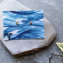 Load image into Gallery viewer, Half moon tiny eco silver studs on watercolour backing card of waves and a whale tail
