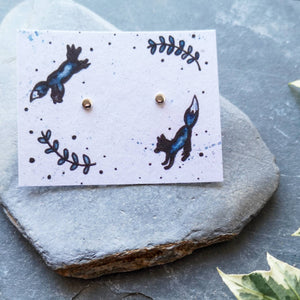 Recycled silver full moon dot studs on recycled cotton backing card with jumping foxes illustration