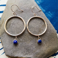Load image into Gallery viewer, Alternative boho silver hoop earrings with blue stones on slate with blue wave background
