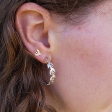 Load image into Gallery viewer, Handmade silver leaf and berry hoop earrings worn with leaf and berry silver stud earrings, close up 
