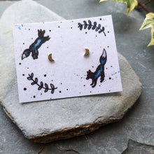 Load image into Gallery viewer, Recycled silver crescent moon studs on recycled cotton backing card with jumping foxes illustration
