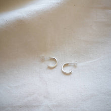 Load image into Gallery viewer, Simple mini silver hoops handmade in Cornwall, on plain calico fabric

