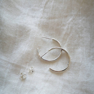 Side profile of handmade recycled silver hoop earrings with scroll backs